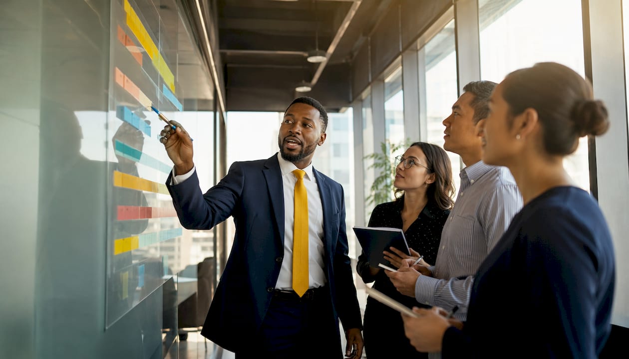 Professional planning timeline on whiteboard in meeting