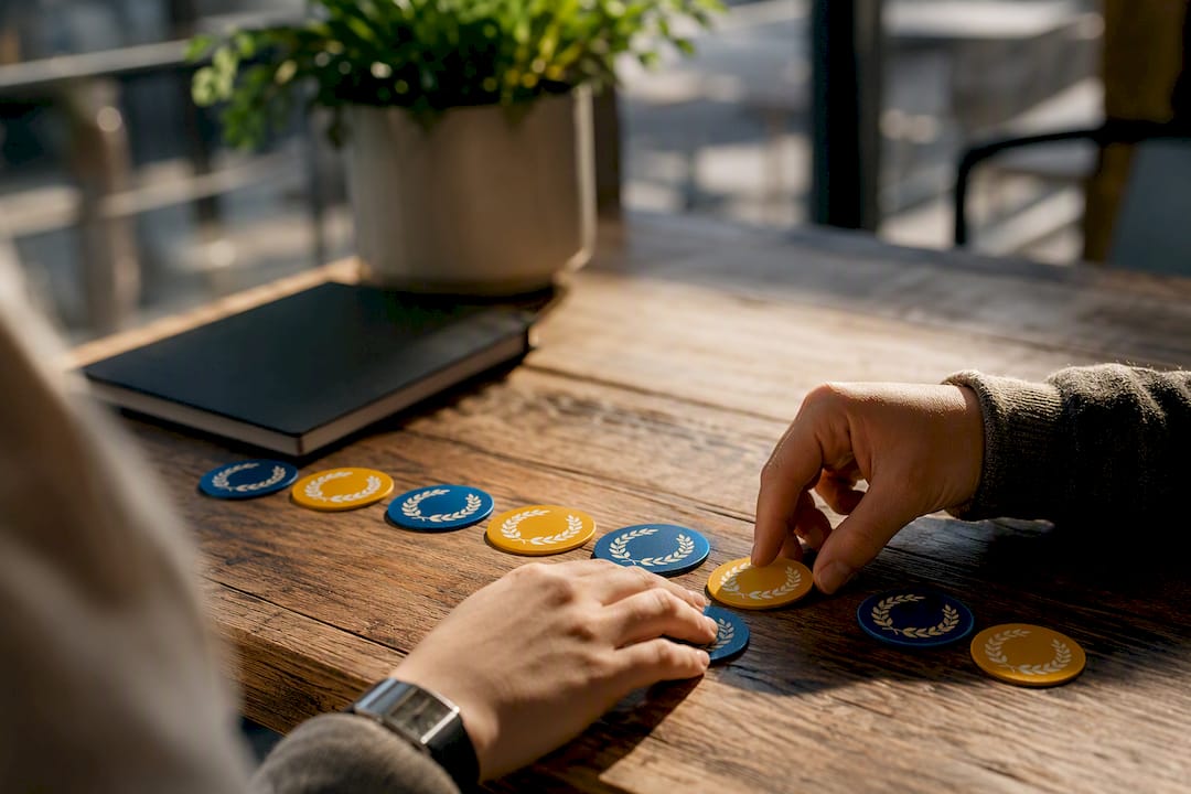 Hands arranging project milestone tokens
