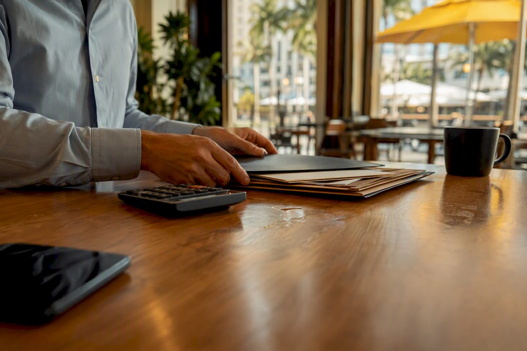 Hands reviewing contracts on office desk