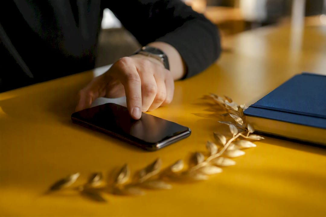 Hand interacting near smartphone and laurel coins