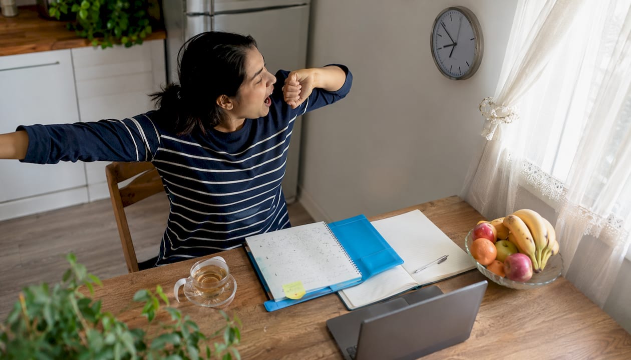 Tired professional woman overwhelmed by time management