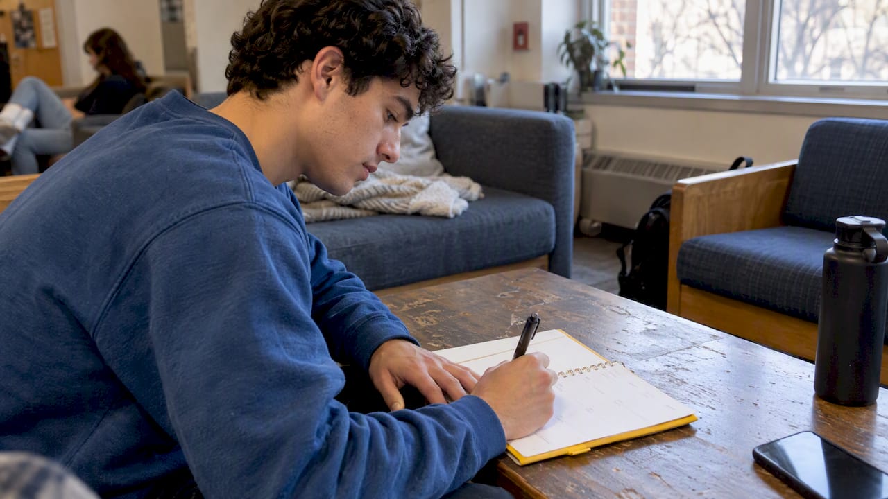 Student assigning time blocks in a paper planner